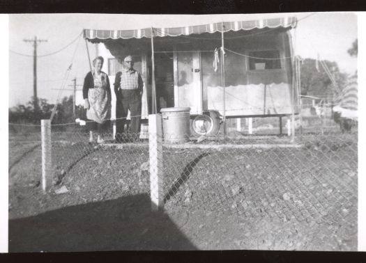 Elderley couple in front of their caravan