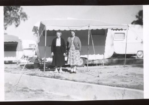 Two women in front of their caravan