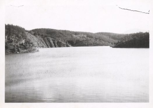 Shows the water backed up from the wall of the Cotter Dam