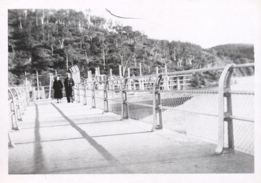 Two women walking on the Cotter Dam wall