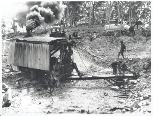 Steam shovel at work. Five workmen in photo.