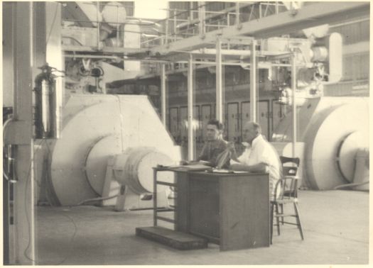 Canberra Diesel Power Station which operated 1953-1980. Shows two men sitting near two turbines.