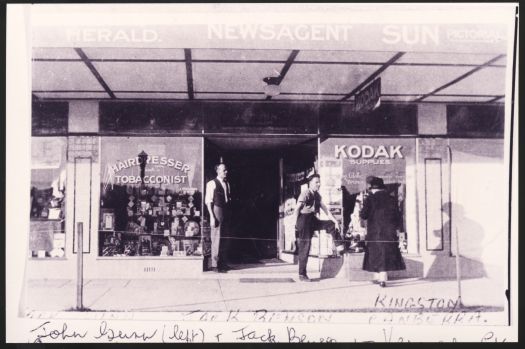 Outside view of the Kennedy Street Newsagency. Left to right: J.G. Gunn, who took over the original shop from J.W. Prowse his brother-in-law, and J.H. Benson (another brother-in-law).