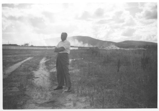 Jack Benson standing in the bed of Lake Burley Griffin. Construction of the lake and Kings Avenue bridge is in the background.