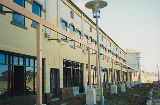 Nearly completed Gungahlin Marketplace from the south. Car park is in front of the shops. Bales of hay for landscaping are at right.