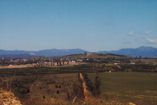 No. 1 in a series of 12 photos providing a panorama of the view from Misery Hill (now Barrer Hill) to Duffy, Stromlo Forest Park, Wright, Coombs, Mt Stromlo, Denman Prospect, Misery Point, Piney Creek, Coppins Crossing, Whitlam, The Pinnacle and Glenloch.