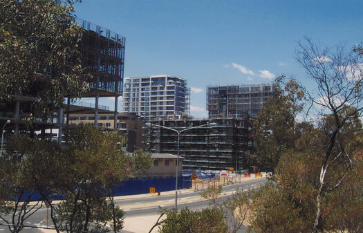 Metropolitan Apartments under construction from rear of Repertory Theatre along Marcus Clarke Street to Gordon Street