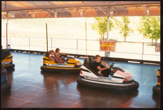 One of nine photos of the rides and entertainment at Canberry Fair showing children driving dodgem cars