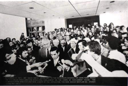 David Smith, Secretary to the Governor General Sir John Kerr, reading the proclamation to dissolve Parliament on the steps of Parliament House. Gough Whitlam stands behind him. 11 November 1975.