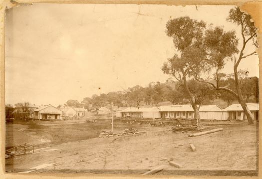 Various buildings around the parade ground under construction.