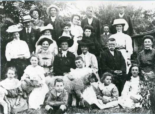Portrait of 22 members of the Sullivan family at Springbank c1906. Two of the children are holding sheep.