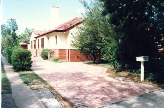 Original brick rendered house probably in Reid showing its driveway and mailbox