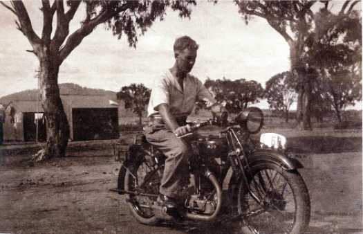 Jack Teasdale sitting on his motorbike, registration FCT 68, at White City with Mt Ainslie in the background