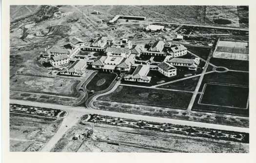 Aerial photograph of the Hotel Canberra showing pavilions and workers huts at the rear. On the back is written "Pavilion marked on right is the one we occupied, one flat of Pavilion marked X is the ballroom".