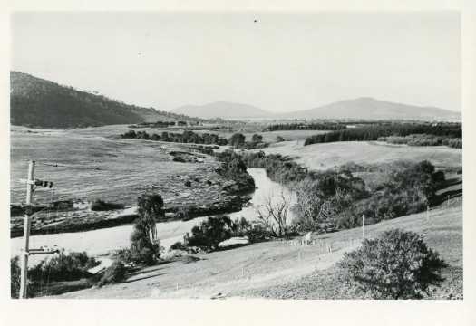View of the Molonglo River probably taken near Yarralumla towards Canberra. Black Mountain is visible at left and Mt Majura and Mt Ainslie in the distance.