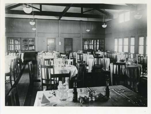 Set tables with chairs in the dining room of Gorman House, previously known as Hotel Ainslie