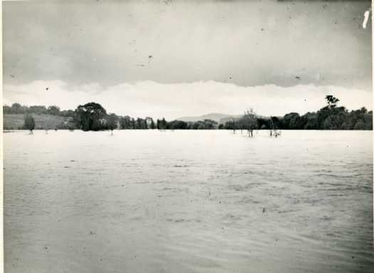 View of a flooded Molonglo River with Black Mountain in the distance