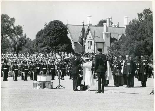Queen Elizabeth, the Queen Mother presenting the Queen's Banner to the Royal Military College, Duntroon, near Canberra, on February 26, after their dedication. The banner was awarded to the College by Her Majesty Queen Elizabeth II during her visit in 1954.