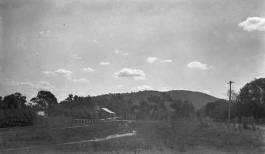 Unnamed hut. A hill is in the mid distance and a telephone pole is at right.