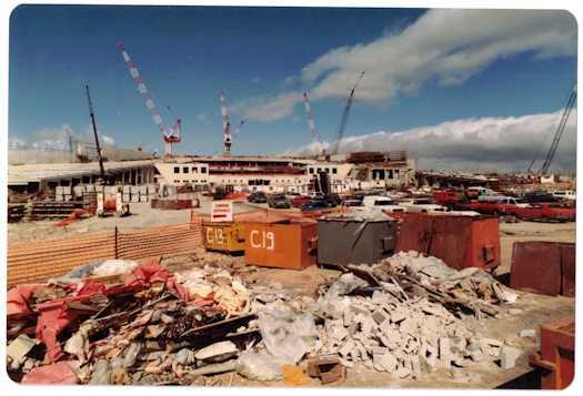 Ground view of the workers' car park with Parliament House under construction