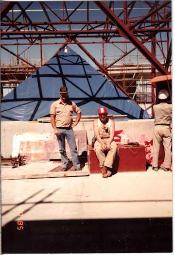 Two workmen photographed in front of the atrium over the Members' Hall.