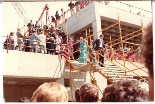 Prince and Princess of Wales walking down temporary stairs