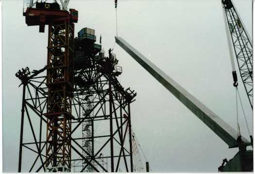 Crane lifting the first leg of the flag pole into position