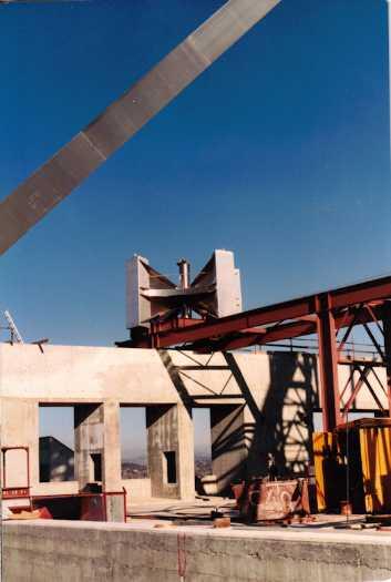 Flag pole cluster positioned beneath legs