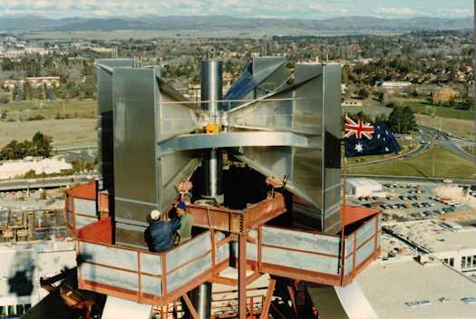 View from a crane of to men working on flag pole hub