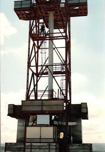 Worker in scaffold surrounding the main flag pole