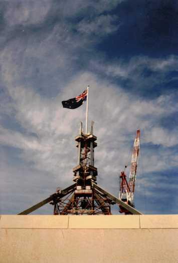 View from below of the Australian flag flying from the mast. The flag mast was erected to its full height in December 1986.