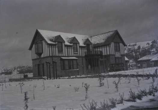 View of the Dial House and new garden in snow, looking to Red Hill.