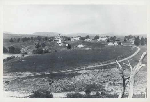 Panoramic view of the 1891 homestead, outbuildings, the Molonglo River and curving driveway.