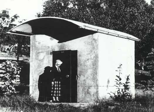 A woman is inspecting the locked door of the plan room.