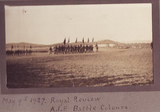 Soldiers marching with flags at the opening of Parliament House on 9 May 1927