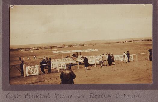 Aviator Bert Hinkler landed at York Park in 1928. Spectators are standing behind a fence looking at the plane.