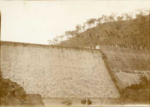 Water flowing over the dam wall.