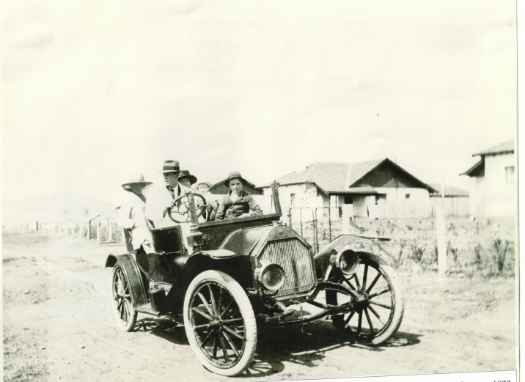The family are shown in car in front of the Power House cottages where they lived - possibly now Gosse Street.