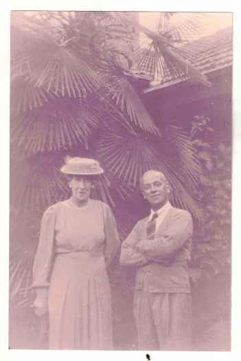 The couple are standing under palm trees in front of their house on the corner of Giles and Jardine streets, Kingston.