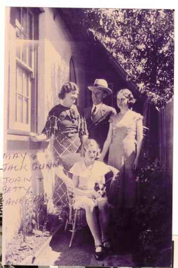 Rear of photo reads: Mary and John Gunn with daughters Bettye and Joan. Residence at rear of Kennedy Street shops. 1929 or later.
