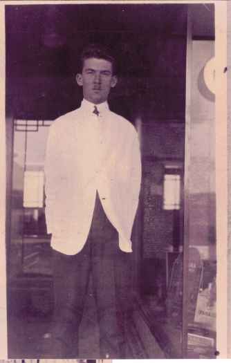Eric Harvie standing in shop doorway.