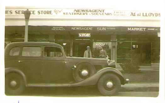 Large car parked outside the newsagent. First owned by JW Prowse and JG Gunn.
