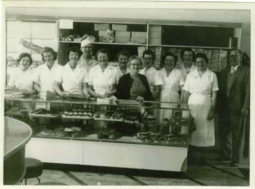 Stewart and Agnes Ogilvie with staff of bakery and cake shop 1957. L to R: Nellie, Margaret, Elsie, Verna, May, Alice, Agnes Ogilvie, Verney, Joan, [illeg], Stewart Ogilvie.