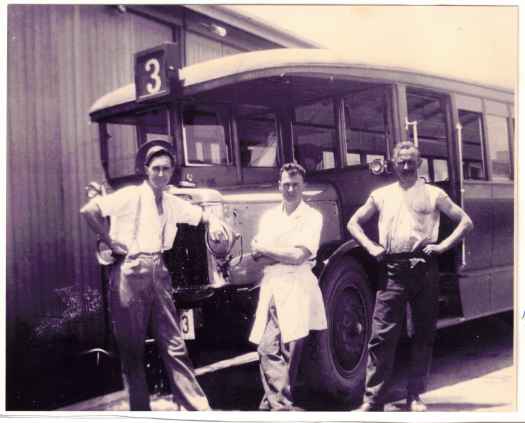 The three men are standing in front of the No 3 bus.