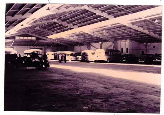 roof fully complete and several busses and cars parked.