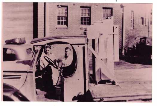 Stan Brill and Bill Ashworth. Gas producer on back of the truck.