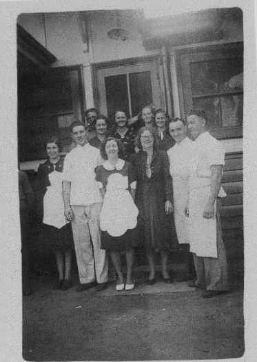 Front: Mary Lloyd, Davey James, Jean McGory, Mrs Nicholas, Mr Nicholas, Arthur Hobbs.
Back: Myrtle Back, ?, ? ,Hilda McJannett, Ted James (left back).