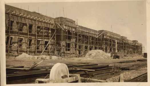 At full height with unrendered bricks and scaffolding.