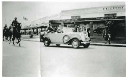 Blurred photograph of the Duke's car and mounted horses accompanying. Victorian Centenary. The Duke planted a tree.