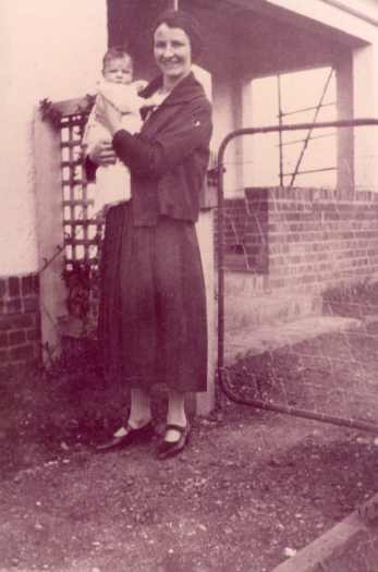 Lettie with baby son John standing outside house at Jardine Street, Kingston.